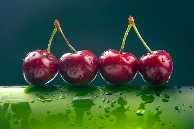 Fresh cherry berry with water droplets on a green bottle.