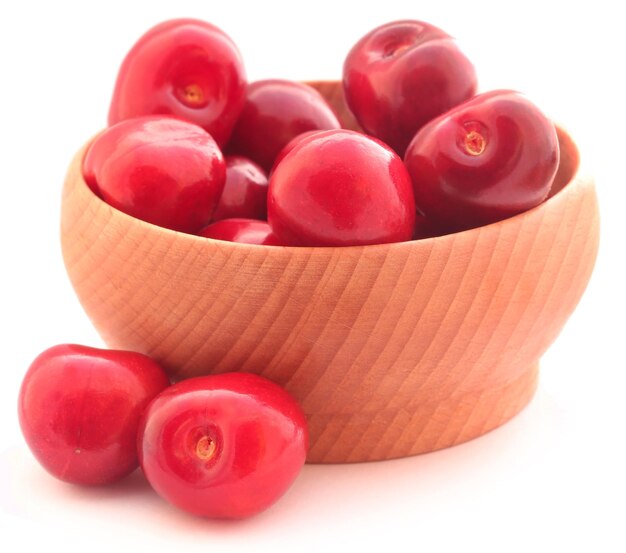 Fresh cherry in a bowl over white background