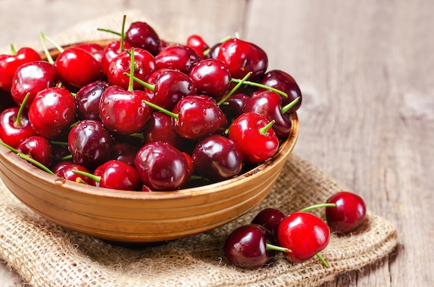 Fresh cherry in a clay bowl.