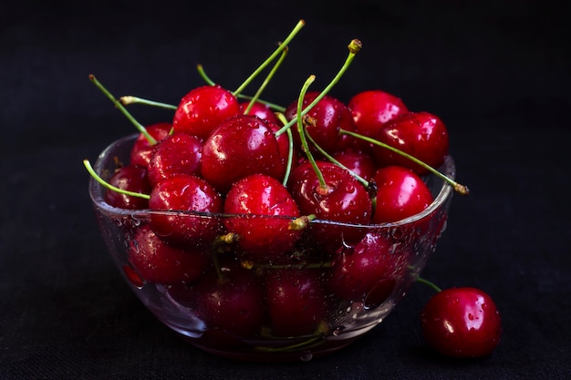 fresh cherry in plate on black