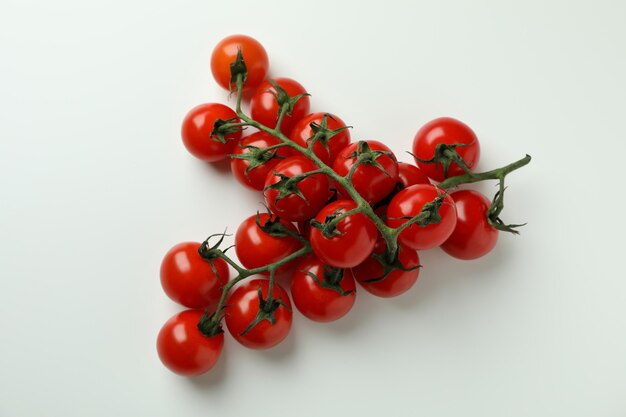 Fresh cherry tomato branches on white background