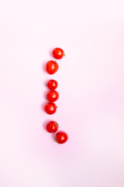 Fresh cherry tomato on st gentle pink background