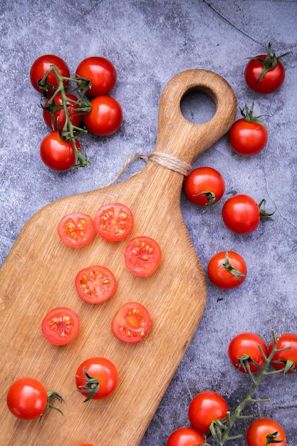 fresh cherry tomatoes and cheese on a black stone board