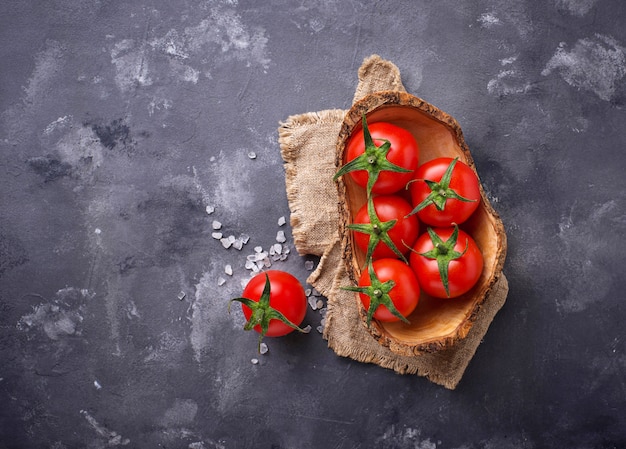 Fresh cherry tomatoes on grey table