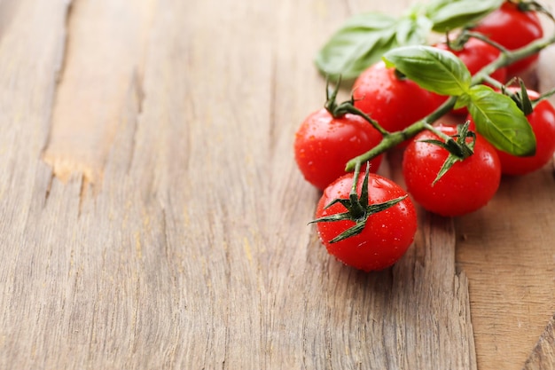 Fresh cherry tomatoes on old wooden table