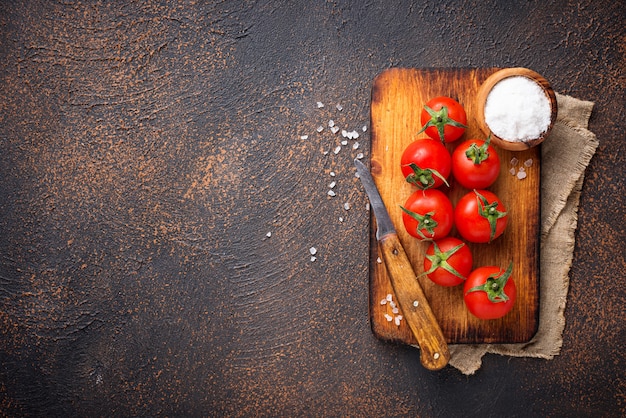 Fresh cherry tomatoes on rusty background