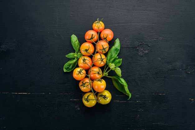 Fresh cherry tomatoes on a twig Top view On the table Free space for text