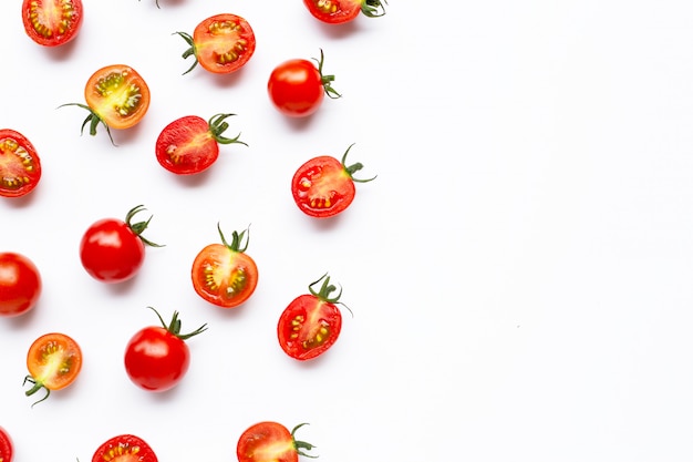 Fresh cherry tomatoes, whole and half cut isolated on white 