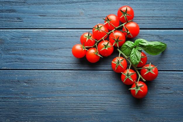 Fresh cherry tomatoes on wooden background