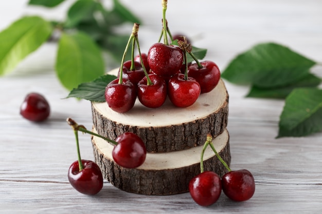 Fresh cherry with water drops on rustic wooden table.