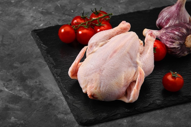 Fresh chicken carcass on a gray background fresh meat copy space photo for grocery stores dark