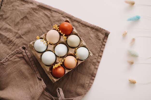 fresh chicken eggs of natural shades and colors on a white background Happy Easter concept