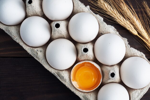 Fresh chicken eggs in a package, raw eggs in a white shell in a box.