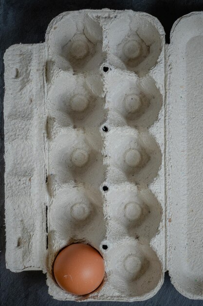 Fresh chicken eggs in a paper tray on the table selective focus