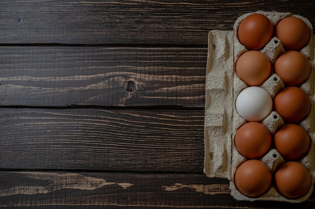 Fresh chicken eggs in a paper tray on the table selective focus