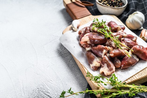 Fresh chicken hearts. Raw offals. White background. Top view. Copy space.