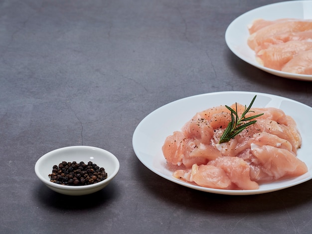 Fresh chicken tenderloin on stone table top