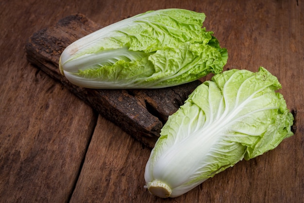 Fresh chinese cabbage on old wooden table background