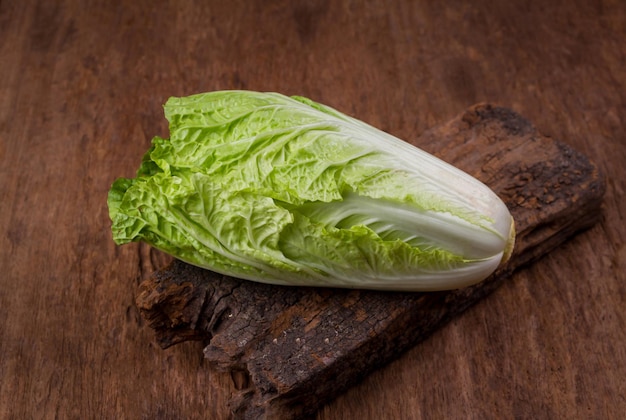 Fresh chinese cabbage on old wooden table background.