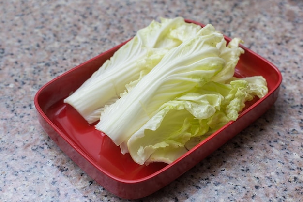Fresh Chinese Cabbage put on a red plate which was served in Shabu or Sukiyaki restaurant.