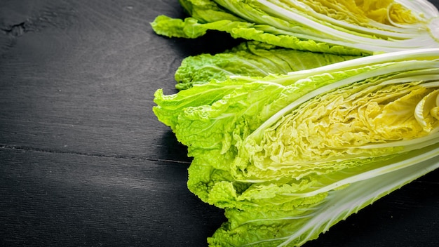 Fresh chinese cabbage on wooden table. Top view.