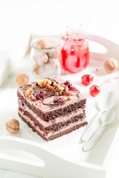 Fresh chocolate cake made of cherries and walnuts