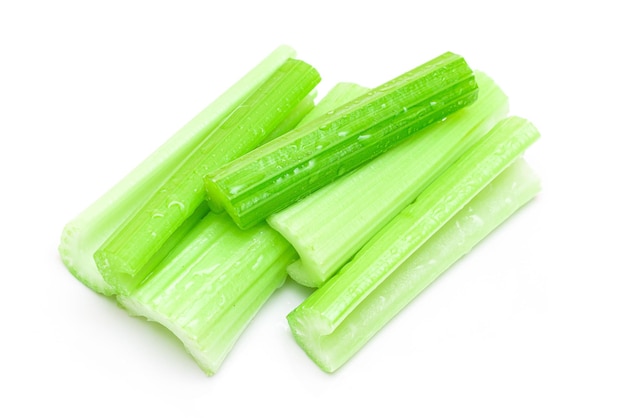 Fresh chopped celery sticks with water drops isolated on white background