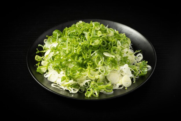 Fresh chopped green onion on dark background