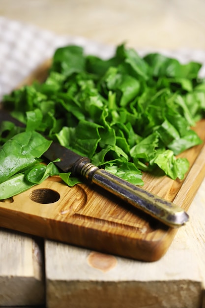 Fresh chopped spinach on a wooden board