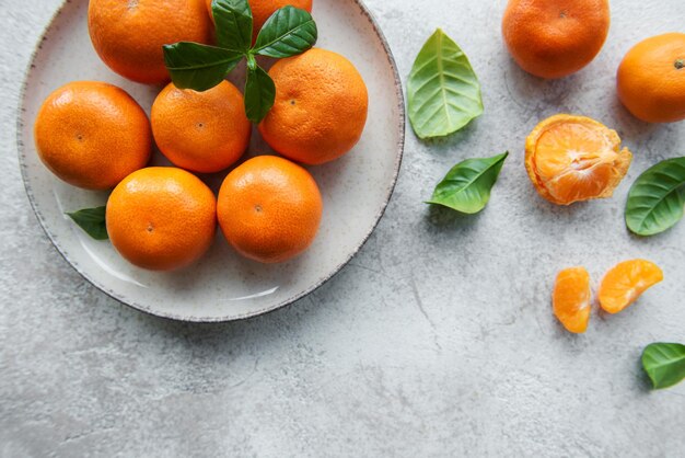 Fresh citrus fruits tangerines oranges on a concrete background