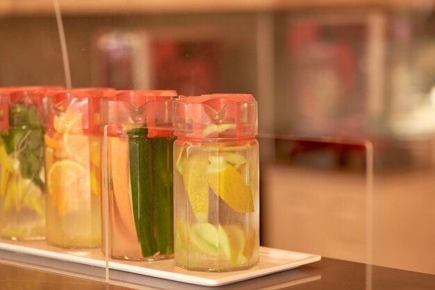 Fresh citrus lemonades in an assortment with lemon and mint on the bar