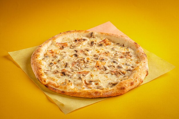 Fresh classic pizza with tomato sauce mozzarella spicy chorizo bell pepper on a yellow background