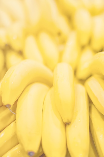 Fresh clear banana sunny yellow background texture vertical light coloured.