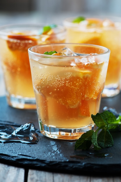 Fresh cocktail with orange, mint and ice