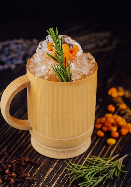Fresh cocktail with sea buckthorn juice rosemary and ice