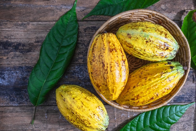 Fresh cocoa in basket On a wooden background