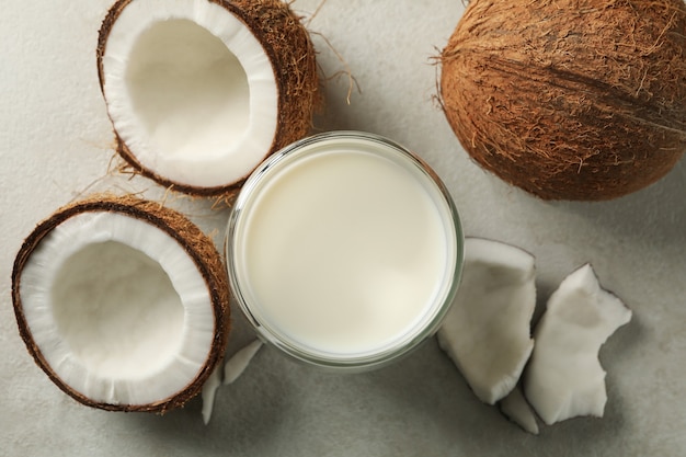 Fresh coconut and coconut milk on white background