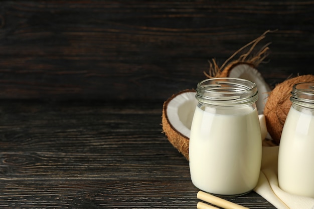 Fresh coconut and coconut milk on wooden background