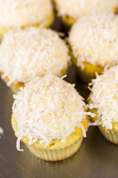 Photo fresh coconut cupcakes on the tray.