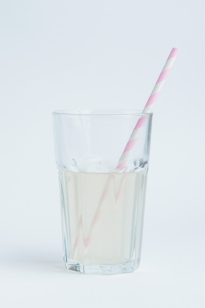 Fresh coconut water in transparent glass with straw
