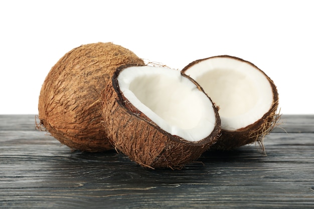 Fresh coconut on wooden table, isolated on white background