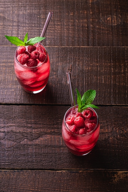 Fresh cold berry juice drinks with mint and straws