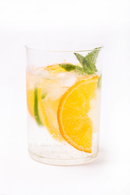 Fresh cold cocktail in glass with sliced citus