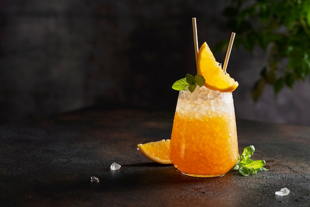 Fresh cold cocktial with orange, crushed ice and mint, and bar concept