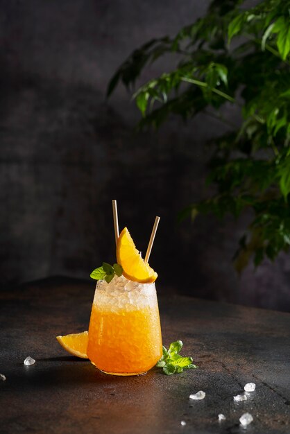 Fresh cold cocktial with orange, crushed ice and mint, and bar concept