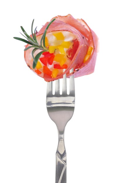 Fresh colorful composition with prosciutto on fork isolated on white