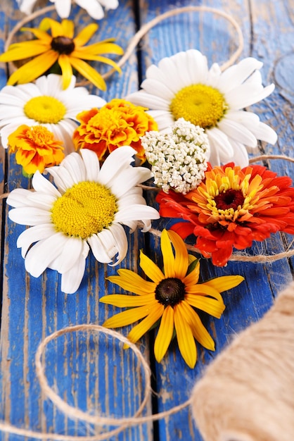 Fresh colorful flowers on wooden table closeup