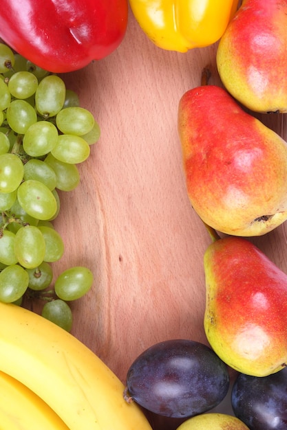 Fresh colorful organic vegetables and fruits with wooden board closeup Farming and healthy food concept with copy space