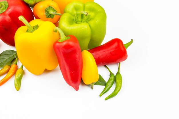 Fresh colorful peppers on the white background