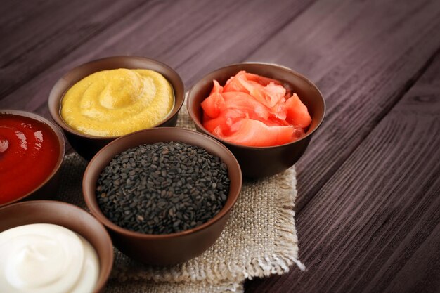 fresh condiments and sauces on wooden background
